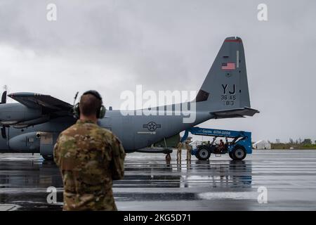 Airmen unload a 36th Airlift Squadron C-130J Super Hercules at the Palau International Airport, Republic of Palau, Oct. 31, 2022. This aircraft transported 23rd Air Expeditionary Wing troops and cargo from Andersen Air Force Base, Guam, to continue a Dynamic Force Employment operation. Stock Photo