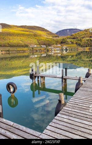 Kaltern, South Tyrol, Italy -14 November 2022 Landing stage at natural bathing lake Caldaro in autumn Stock Photo