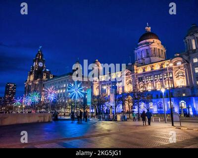 Night-time street scenes in Liverpool from Pier Head looking toward the Three graces of the Liver, Cunard Shipping, and the Port of Liverpool building Stock Photo