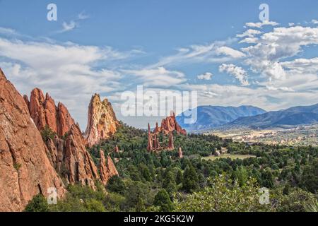 Garden of the Gods - jutting tall red eroded rock formations near Colorado Springs and Pikes Peak USA - View from distance with Rocky Mountains in dis Stock Photo