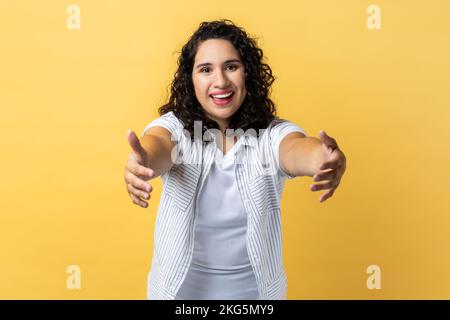 Friendly pleasant good-looking woman in matching outfit holding smartphone  over chest tilting head smiling broadly showing cute gapped teeth being  Stock Photo - Alamy