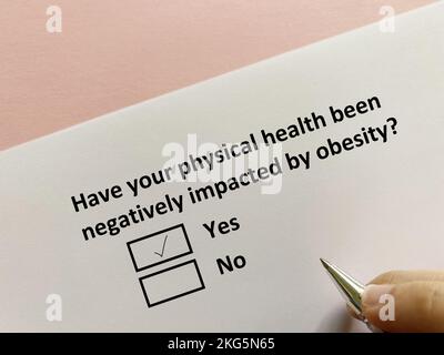 One person is answering question about diet. His physical health has been negatively impacted by obesity. Stock Photo