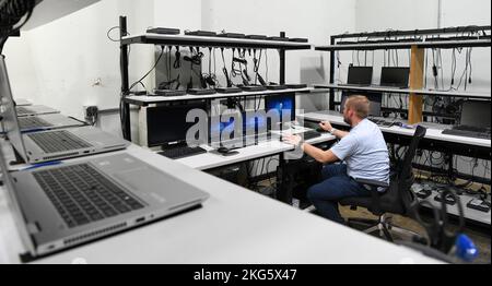 Jonathan Poe, a computer network technician IV, works in the computer staging area to prepare computers for deployment to users Oct. 5, 2022, at Arnold Air Force Base, Tennessee. Arnold Engineering Development Complex (AEDC),Computer Network Technician,Information Technology (IT), Stock Photo