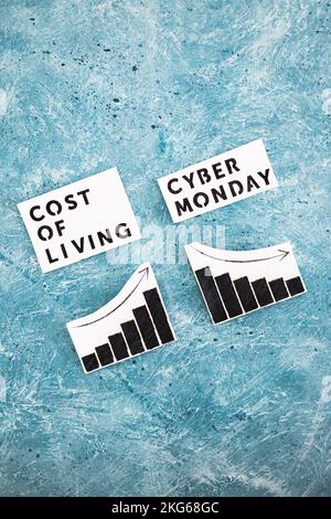 Cost of Living vs Cyber Monday conceptual image with graphs showing price going up and consumer spending going down Stock Photo