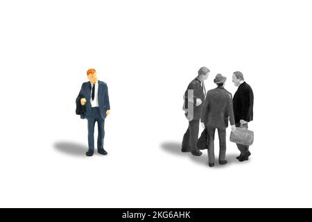 Miniature people toy figure photography. Office gossip concept. A businessman worker talking about someone. Isolated on white background. Image photo Stock Photo