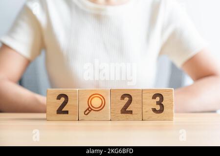 2023 block with magnifying glass icon. SEO, Search Engine Optimization, hiring , Advertising, Idea, Strategy, marketing, Keyword, Content and New Year Stock Photo