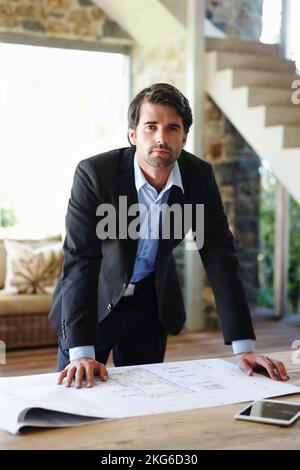 These are plans for the new building. An attractive draughtsman working on his floor plan. Stock Photo
