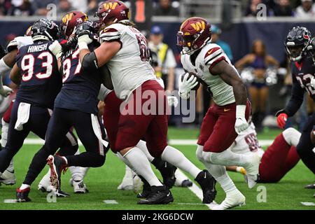 Washington Commanders running back Brian Robinson Jr. (8) works out ...