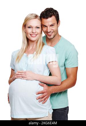 Great expectations. A smiling husband holding his pregnant wifes stomach from behind. Stock Photo