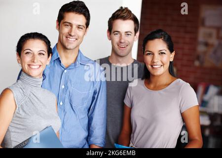 Theyre excited about their business proposal. Portrait of a successful design team smiling confidently. Stock Photo