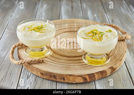 Lemon mousse, lovely French recipe dessert on wooden background. Stock Photo