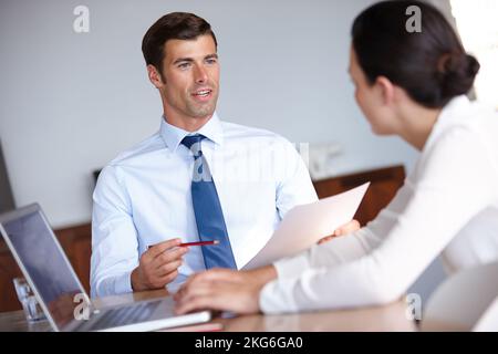 What do you think we should do. two business colleagues working together in an office. Stock Photo