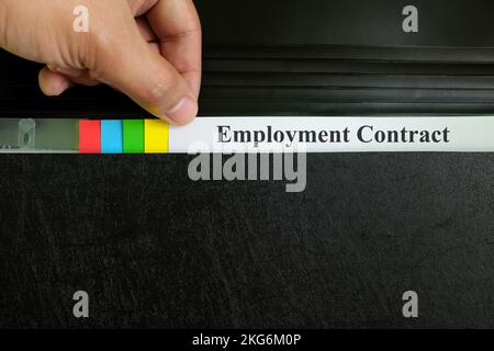 Employment contract file in black binder folder. Human resources concept. Stock Photo
