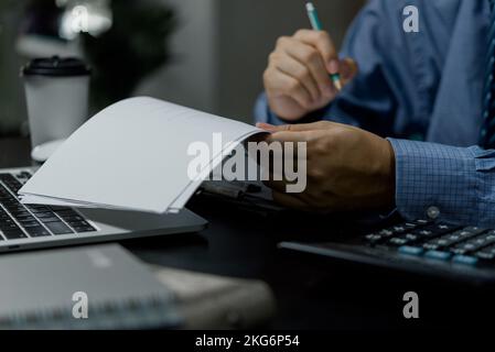 Businessman checking document data accounting and paperwork tax finance or reading law information.Business report contract signature on desk. Stock Photo