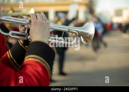 Military band in parade. Trumpeters on street. Trumpeter plays tune. Orchestra in Russia. Red ceremonial uniform. Stock Photo