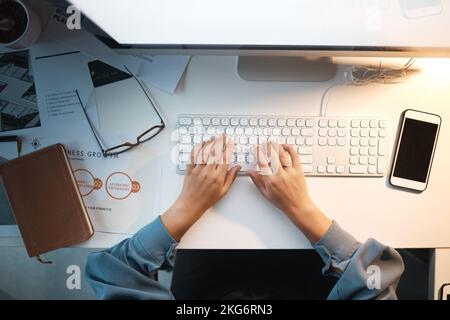 Computer, keyboard and typing with top view of woman and mockup on screen for research, planning and growth analytics. Technology, innovation and Stock Photo