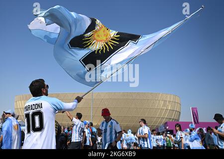 22 November 2022, Qatar, Lusail: Soccer, 2022 World Cup in Qatar, Argentina - Saudi Arabia, preliminary round, Group C, at Lusail Stadium, Argentina fans celebrate outside the stadium before the start of the match. Photo: Robert Michael/dpa Stock Photo