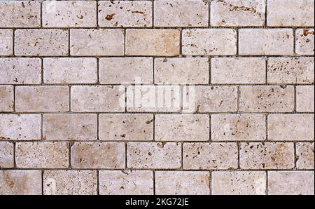 Stone decorative masonry wall background. Bricks made of natural stone surface backdrop. Design, decor, copy space. High quality photo Stock Photo