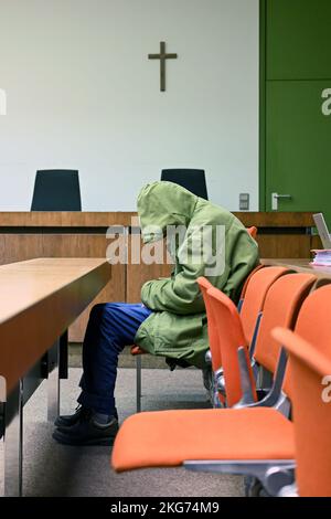 Munich, Germany. 22nd Nov, 2022. The defendant sits in his seat in the courtroom, hiding his face behind his hood. The 85-year-old defendant has to answer for manslaughter of his dependent wife. Credit: Tobias Hase/dpa/Alamy Live News Stock Photo