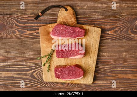 Top view of raw fresh eye of round steak on cutting board Stock Photo