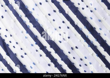 White fabric with blue stripes and wooly dots Stock Photo