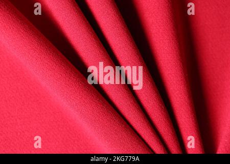 Soft folded bright red textile material textured background Stock Photo