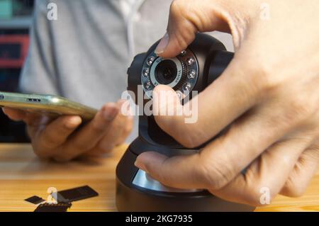 Conceptual man operating ip camera Stock Photo