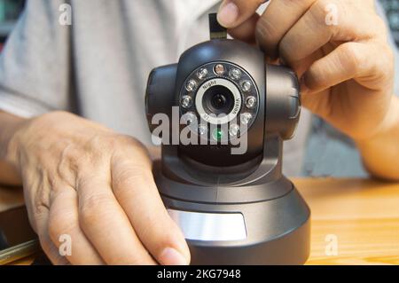 Conceptual man operating ip camera Stock Photo