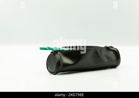 black leather pen holder and pens inside Stock Photo