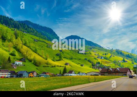 Countryside road in village, Alt Sankt Johann, Sankt Gallen, Switzerland Stock Photo