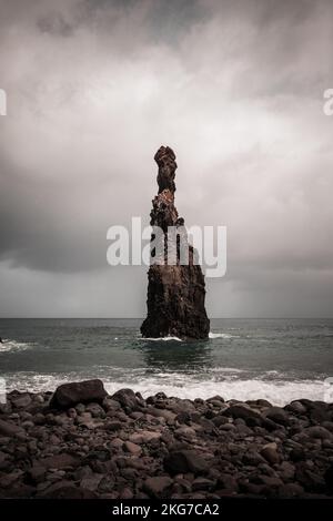 The big islet of Ribeira da Janela in Porto Moniz, Madeira island, Portugal. Surreal landscape of a large rock formation in the ocean near the coast Stock Photo