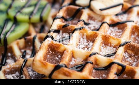 Close-up, Belgian waffles with fruits, covered with chocolate. Stock Photo