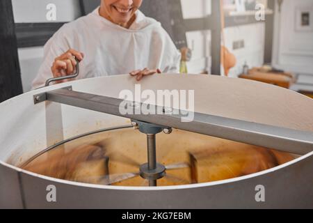 Machine, beekeeper and honey in production in a factory at sustainable, agriculture and agro bee farm. Mixer, manufacturing and woman farmer in Stock Photo