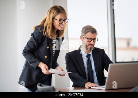 Shot of two businesspeople working on a laptop in the boardroom. Teamwork at the office. Stock Photo