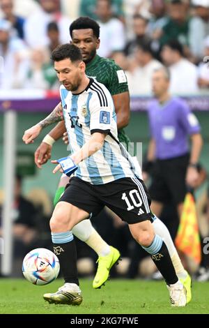 Lusail, Qatar. 22nd Nov, 2022. Soccer, 2022 World Cup in Qatar, Argentina - Saudi Arabia, preliminary round, Group C, at Lusail Stadium, Argentina's Lionel Messi (front) and Saudi Arabia's Ali Al-Bulaihi in a duel. Credit: Robert Michael/dpa/Alamy Live News Stock Photo