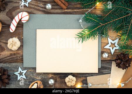 Blank paper, envelope and Christmas decor on wooden background, copy space. Stock Photo