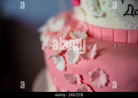 Details of a butterfly and flowers on a children kids pink cake bakery. Happy birthday girl. High quality photo Stock Photo