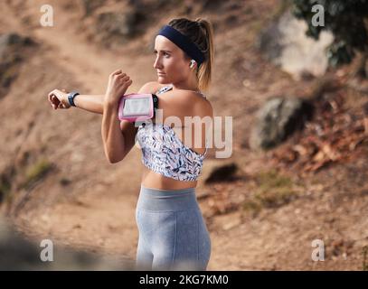 Woman runner, arm stretching and outdoor hiking on trail, hill or mountain for workout, fitness or health. Girl, warm up and running in nature for Stock Photo