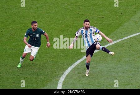 Argentina's Lionel Messi (right) and Saudi Arabia's Abdulellah Al-Malki during the FIFA World Cup Group C match at the Lusail Stadium, Qatar. Picture date: Tuesday November 22, 2022. Stock Photo