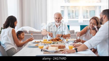 Family, breakfast and food with a senior man eating during a visit from his children and grandchildren at home. Kids, love and celebration with Stock Photo
