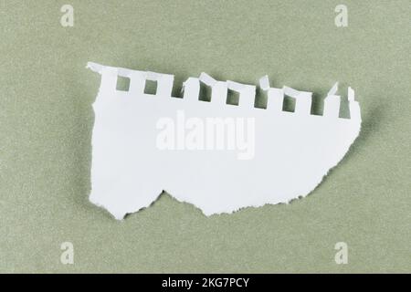 Ripped up piece of white paper with copy space on cardboard background Stock Photo