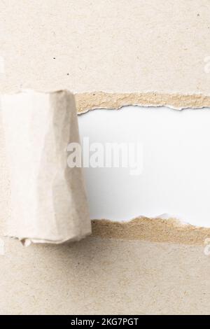 Ripped up piece of beige paper with copy space on white background ...