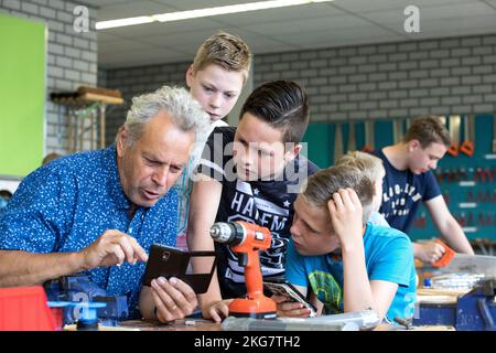 Student working in the technasium with the teacher of a secondary school. Holland. vvbvanbree fotografie. Stock Photo