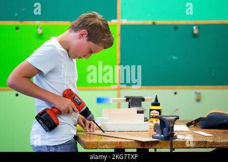 Student working with a drill  in the technasium of a secondary school. Holland. vvbvanbree fotografie. Stock Photo