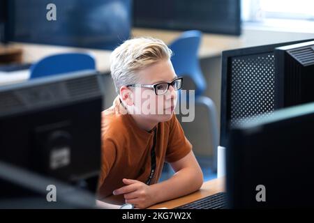 Student on a secondary school works with computer in a classroom. Holland. vvbvanbree fotografie Stock Photo
