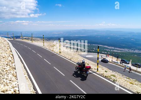 BEDOIN, FRANCE - AUGUST 7, 2022: Motorcyclist on the top of Mont Ventoux. At 1,909 m (6,263 ft), it is the highest mountain in the region and has been Stock Photo
