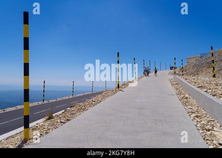 BEDOIN, FRANCE - AUGUST 7, 2022: People walking to the top of the Mont Ventoux. At 1,909 m (6,263 ft), it is the highest mountain in the region and ha Stock Photo
