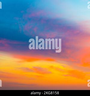 Beautiful sunset sky with amazing colorful clouds against deep blue Stock Photo