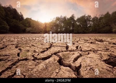 Dry and cracked mud ground during the summer drought, rough surface, texture with desiccation cracks Stock Photo