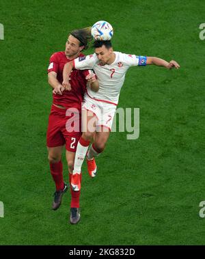 Tunisia's Youssef Msakni (right) and Denmark's Joachim Andersen battle for the ball during the FIFA World Cup Group D match at Education City Stadium, Al Rayyan. Picture date: Tuesday November 22, 2022. Stock Photo